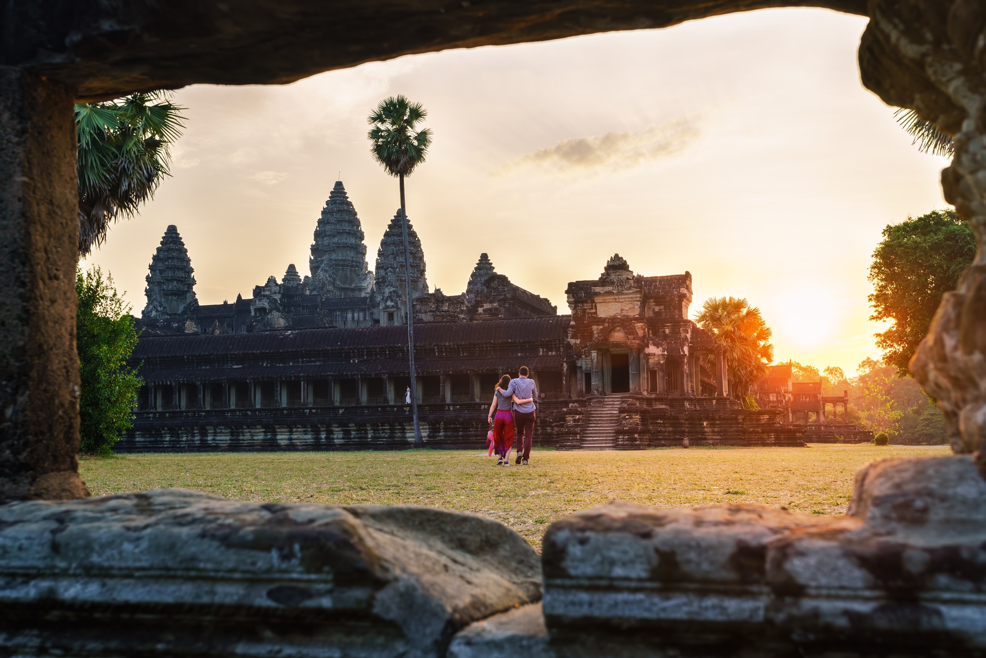 Travel-couple-in-Angkor-Wat-at-sunrise-moment-Siem-Reap-Cambodia.jpg