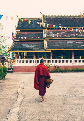 Buddhist monks morning rituals at Wat Chomkao Manilat temple Laos