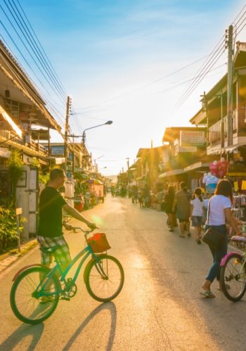 Chiang Khan Loei Thailand Tourists walking and cycling in walking street of retro village