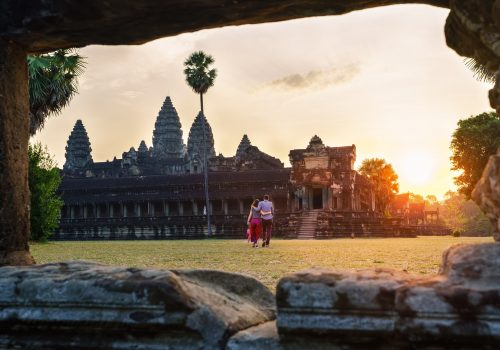 Travel-couple-in-Angkor-Wat-at-sunrise-moment-Siem-Reap-Cambodia