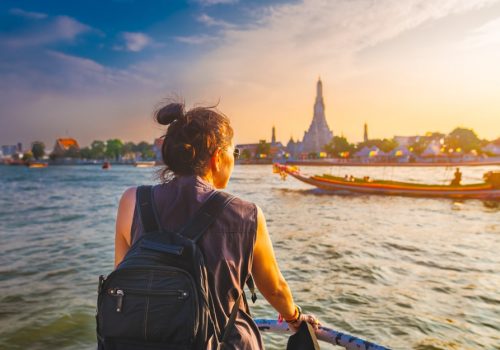 boat view Wat Arun at sunset Chao Phraya river Famous water landmark travel Bangkok Thailand