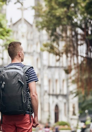 cathedral man with backpack in Hanoi Vietnam